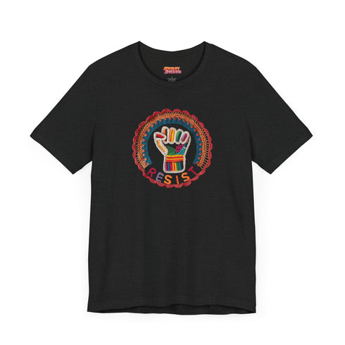Black short-sleeve t-shirt featuring a bold embroidered design centered on the chest. The design showcases a raised fist wrapped in multicolored thread, symbolizing strength and resistance. Surrounding the fist is a circular embroidered border with intricate, colorful stitching in shades of red, orange, blue, and yellow, creating a striking contrast against the black fabric. Below the fist, the word "RESIST" is embroidered in capital letters using a gradient of warm-toned thread. The t-shirt has a classic c
